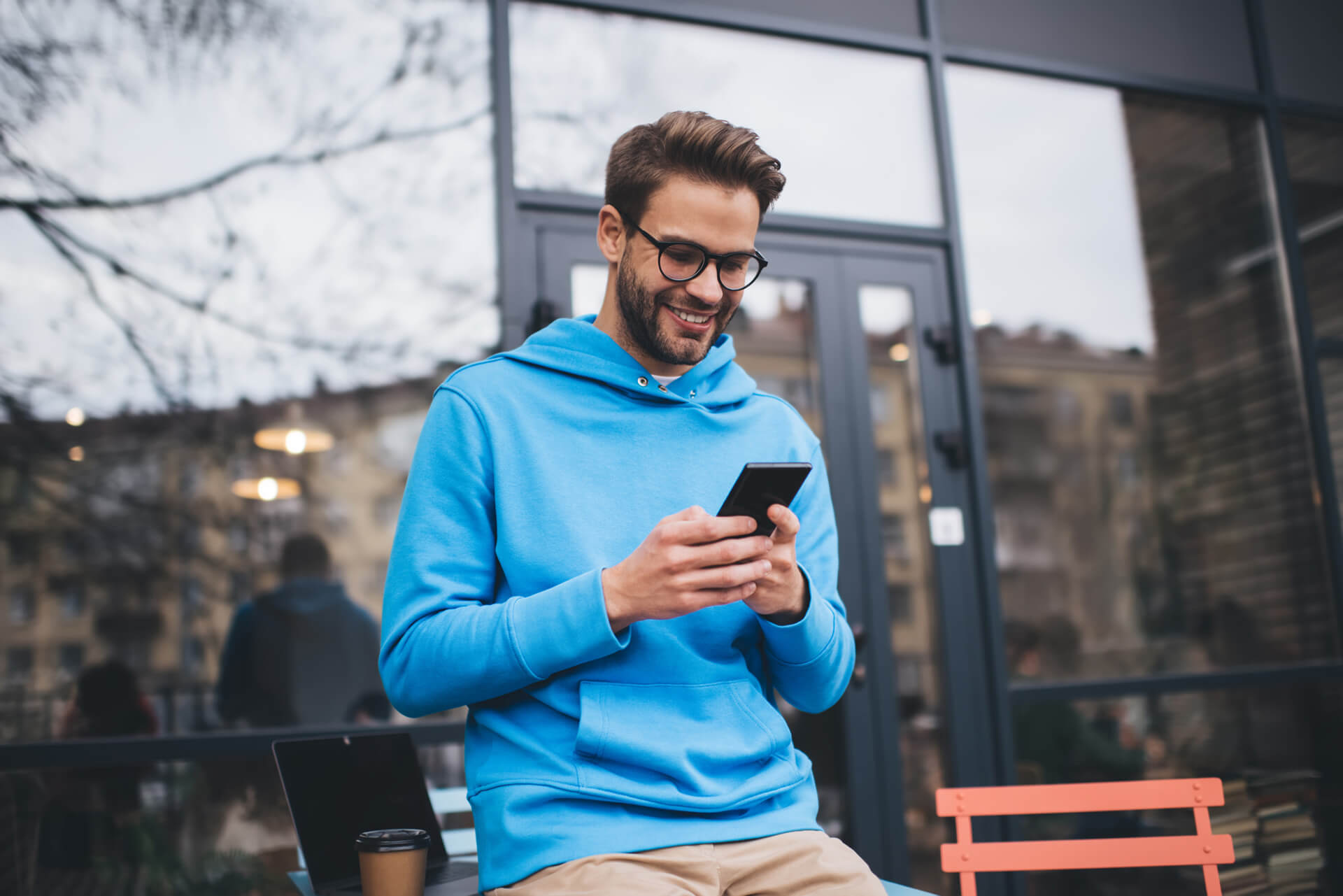 Smiling person looking at phone